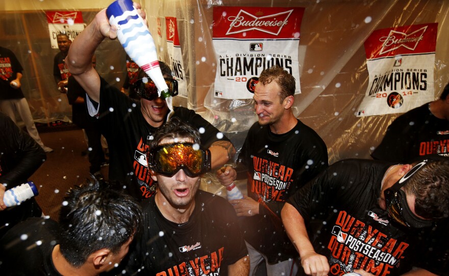 The Baltimore Orioles celebrate in the locker room after their win over the Detroit Tigers on Sunday.