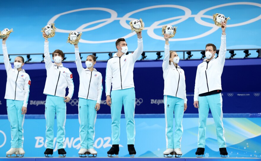 Gold medalists Team ROC pose during the Team Event flower ceremony at Beijing 2022 Winter Olympic Games on Monday, February 7. That medal is now in doubt following questions about Kamila Valieva's eligibility following her positive drug test.