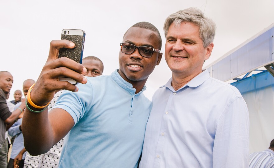 Babajide Bello of the tech company Andela takes a selfie with AOL's Steve Case after the pair played a pickup game of ping-pong.