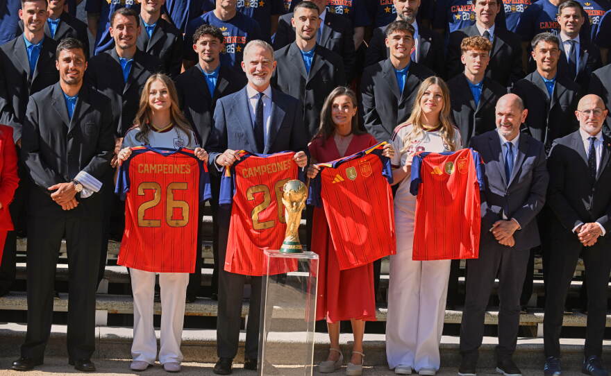 Spain's King Felipe VI and Queen Letizia, accompanied by Princess Leonor, left, and Infanta Sofia, right, pose with players from Spain's national soccer team at Zarzuela Palace in Madrid on Monday, July 20, 2026, after the team was crowned World Cup champion.