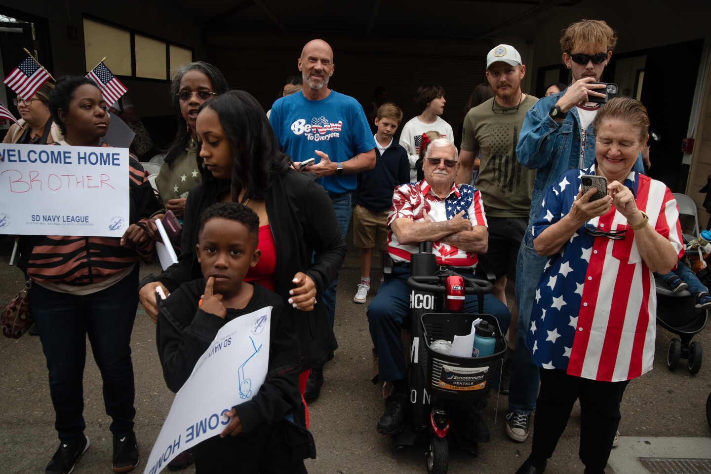 Two families wait for their loved one aboard the aircraft carrier Theodore Roosevelt on Oct. 15, 2024 at the Naval Air Station North Island on Coronado Island.