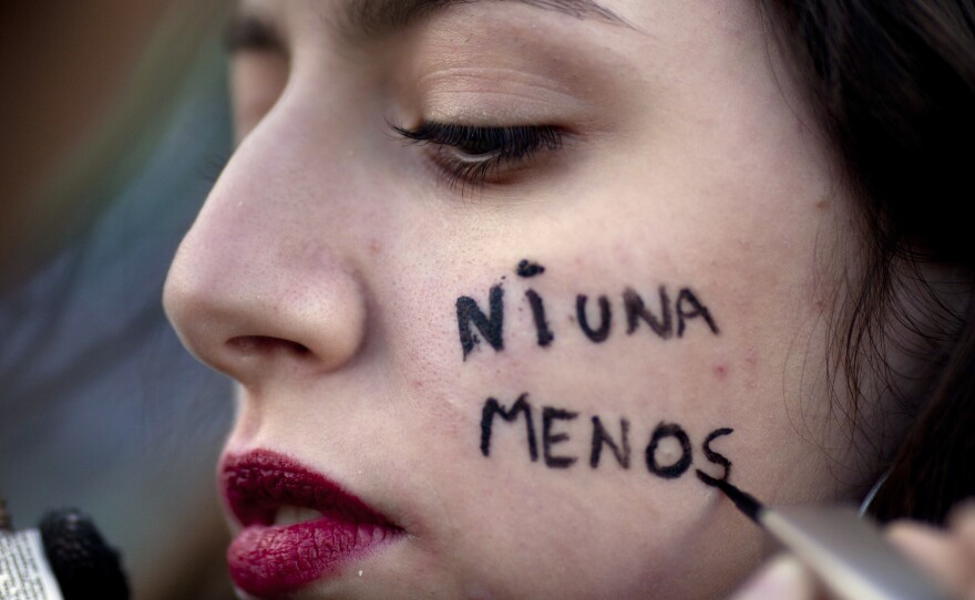 A protester has the Spanish message "Not one less" painted on her cheek during a pro-life demonstration in Buenos Aires on June 4, 2018.
