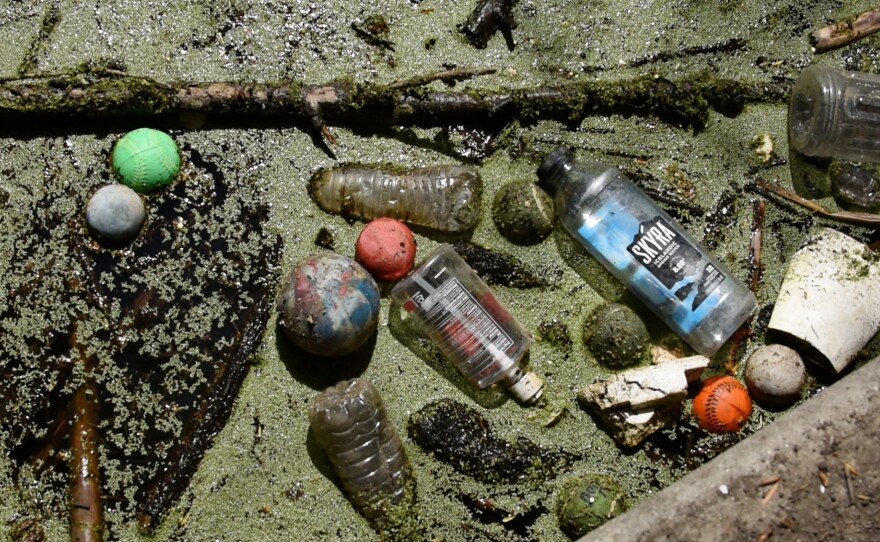 Litter consisting of plastic water bottles and various athletic balls flooding in the duck pond in the Buena Vista Creek Trail in Vista, Calif. on April 18, 2024.