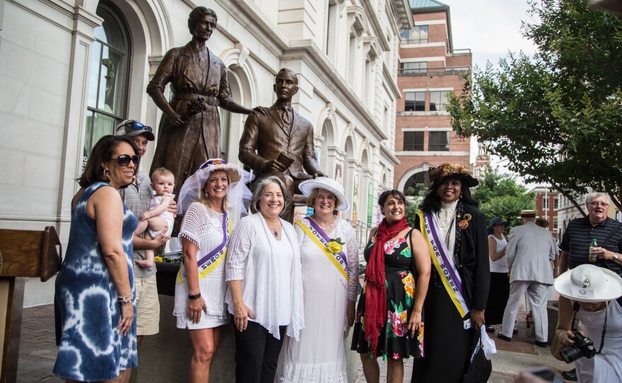 Suffrage Coalition President Wanda Sobieski (third from right, in suffrage regalia) and other coalition members pose with the statue of Febb and Harry Burn at the unveiling of the Burn Memorial in Knoxville, Tenn., in June 2018.