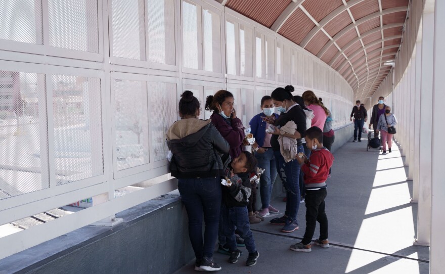 A group of migrants rapidly deported from the U.S. under Title 42 wait on the Mexican side of the Paso del Norte International Bridge, between El Paso, Texas and Ciudad Juarez, Mexico on March 10.