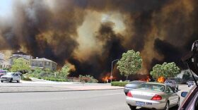 The Poinsettia fire, fueled by strong Santa Ana winds and extreme drought conditions, burns through a neighborhood in Carlsbad, May 2014.