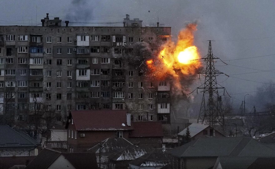 An explosion is seen on March 11 in a Mariupol apartment building after a Russian army tank fires.