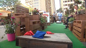 People toss bean bags in a parking spot remade into an urban park for Park(ing) Day in downtown San Diego, Sept. 16, 2016.