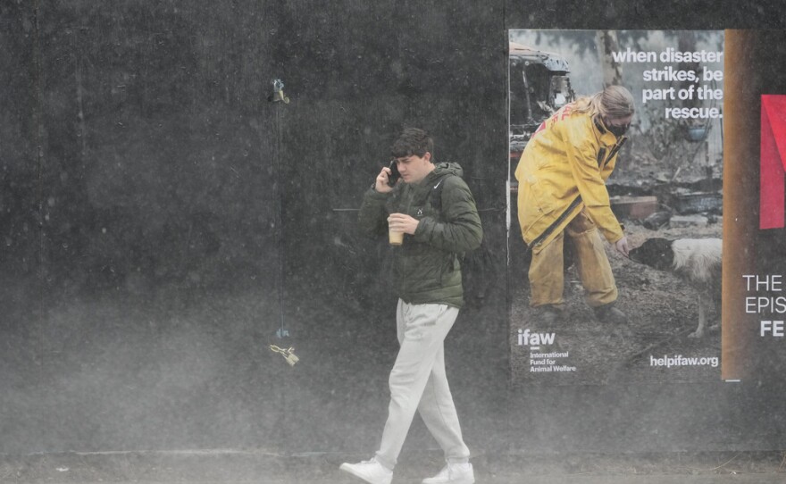 A pedestrian walks in the rain Thursday, Feb. 13, 2025, in Los Angeles.