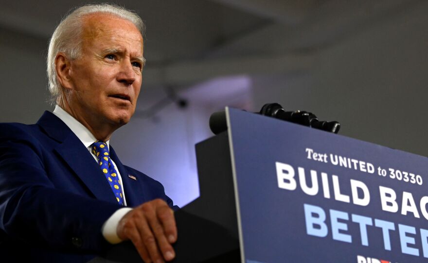 Presumptive Democratic nominee Joe Biden, seen here at a campaign event in July, says he won't tear down the border wall put in place during the Trump administration.
