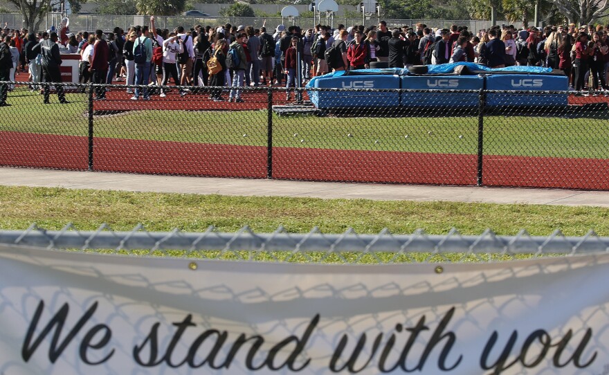 Students from Marjory Stoneman Douglas High School gather on the football field on Wednesday to honor the memories of 17 people who were killed during a mass shooting at the school in Parkland, Fla., on Feb. 14.