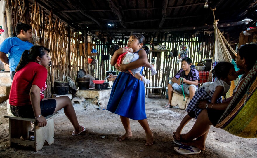In many Mexican communities, children have the chance to contribute to their families by helping take care of toddlers and babies. Here, Ruby holds her cousin Daphne in her grandmother's home.