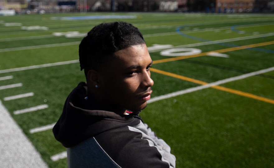 Kahlil Brown, 18, says teammate Deshaun Hill Jr., the student and quarterback who was shot and killed in 2022, was his best friend. Brown, shown posing for a portrait at the North Community High School football field in Minneapolis on April 9, will attend St. Olaf College in the fall.