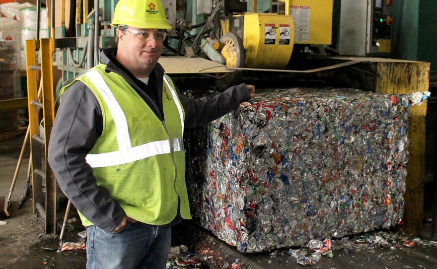 Republic Services' recycling general manager Brent Batliner explains how aluminum cans are compressed into 1500-pound bales at his company's MRF in Hazelwood, Mo. Valued at about $1200 per ton, aluminum is the most lucrative recyclable product sold by MRFs.