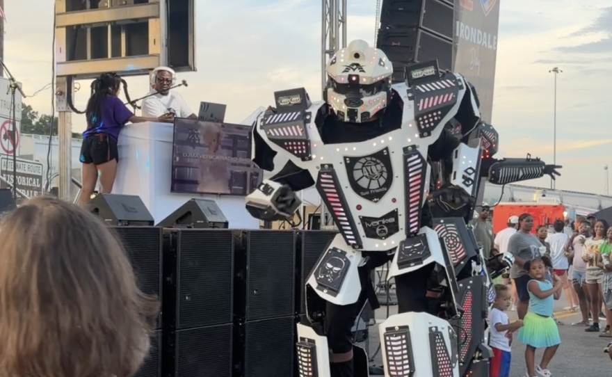 A dancer on stilts is dressed as a robot -- but not doing "the robot" -- at I Love Irondale Day, July 22, 2026.