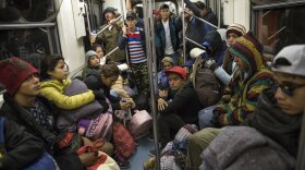 Central American migrants ride on the subway after leaving the temporary shelter at the Jesus Martinez stadium, in Mexico City, Friday, Nov. 9, 2018. About 500 Central American migrants headed out of Mexico City on Friday to embark on the longest and most dangerous leg of their journey to the U.S. border, while thousands more were waiting one day more at the stadium.
