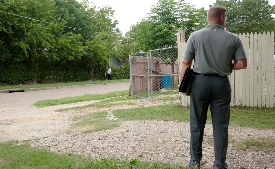 Cheryl Wattley and Daryl Parker measure the distance between locations at the crime scene in June 2017.