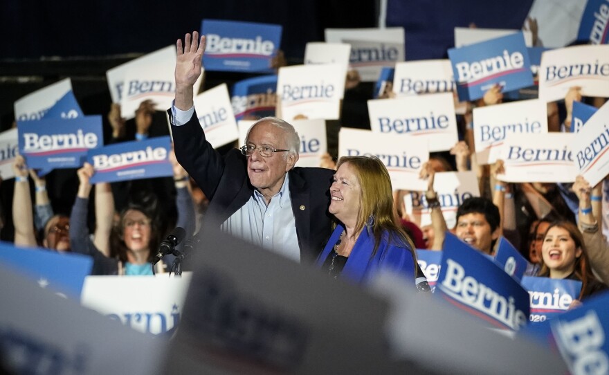 After winning the Nevada Democratic caucuses, Vermont Sen. Bernie Sanders, with his wife, Jane Sanders, waves as they exit the stage at a campaign rally Saturday in San Antonio.
