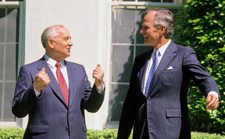 Soviet President Mikhail Gorbachev (left) and former U.S. President George H.W. Bush share a light moment together outside the White House in 1990. Could they be discussing chicken?