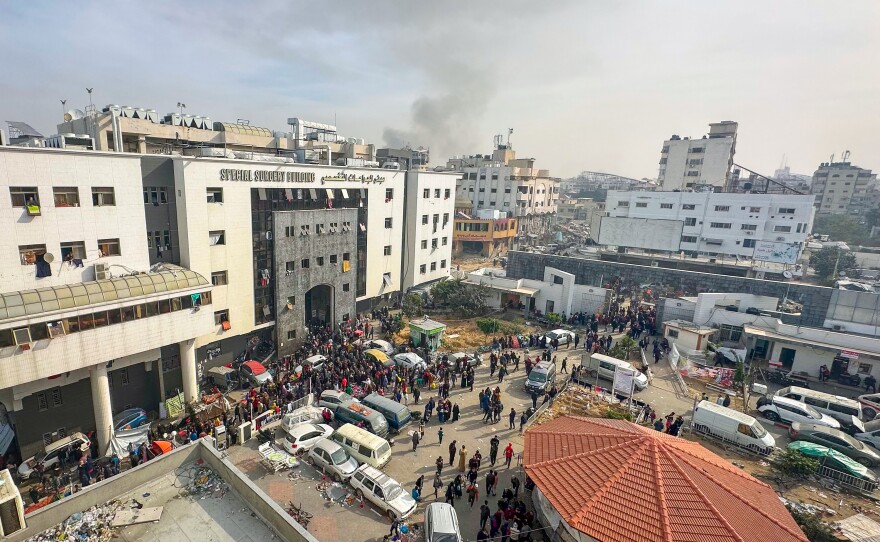 Displaced Palestinians gather in the yard of Gaza's Al-Shifa hospital on December 10 as battles continue between Israel and the militant group Hamas.