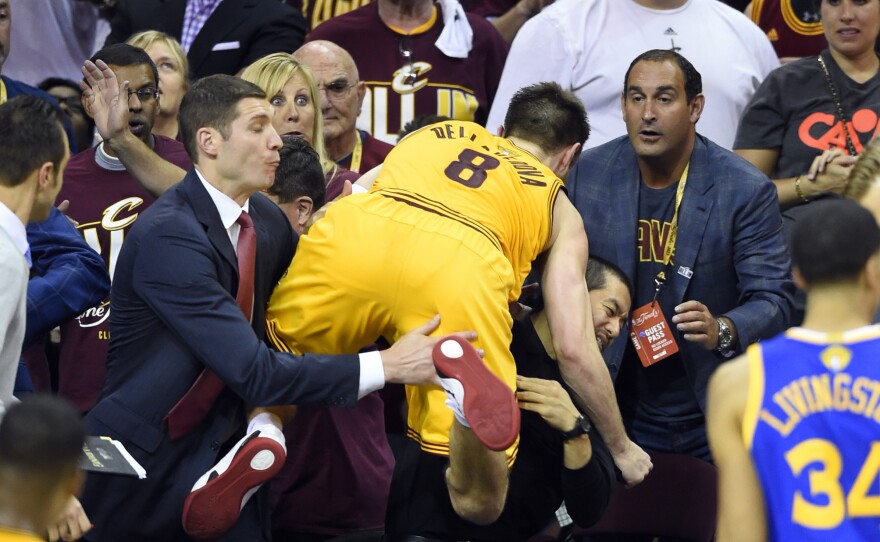 Cleveland Cavaliers guard Matthew Dellavedova falls into the crowd Tuesday night during the third quarter of Game Three of the NBA Finals. The Australian has had an expanded role since late in Game One, when point guard Kyrie Irving injured his knee.