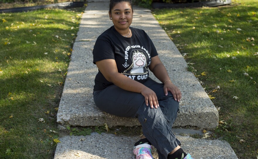 Melanie Medina, 20, poses for a portrait outside her apartment building in Greenfield, Wis., on Sunday. Medina works as a dental receptionist, and identifies as left leaning politically.