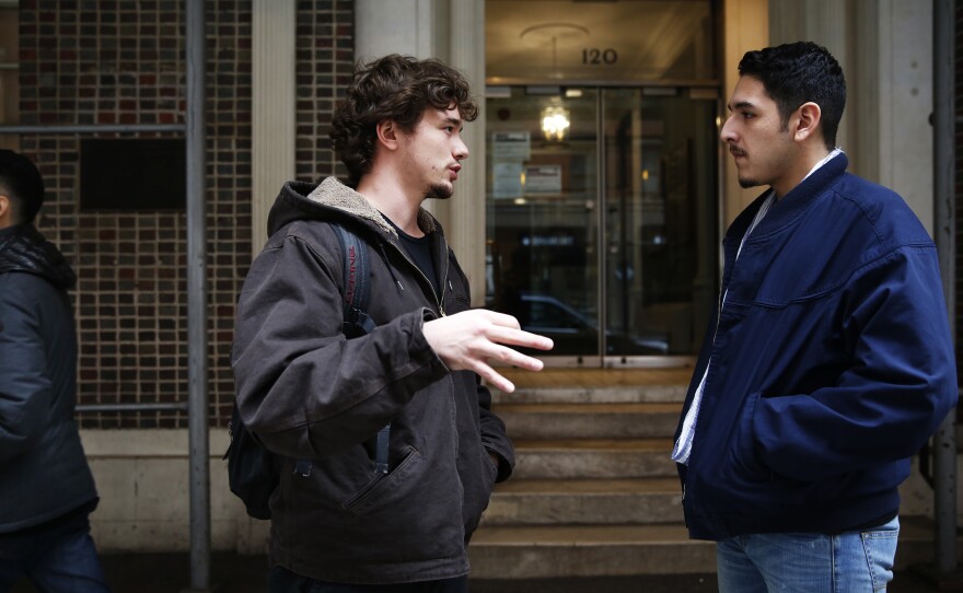 Meile talks with a fellow student outside his school's main building in Manhattan.