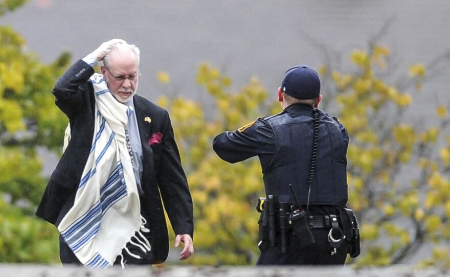 Rabbi Jeffrey Myers and a police officer outside of the Tree of Life synagogue on Oct. 27, 2018.