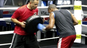 L.A. Matadors head coach Manny Robles works with a team member during training session at The Rock boxing gym in Carson, Calif.