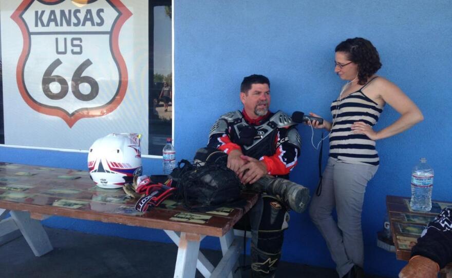 Dudley Pratt (left) talks to reporter Jenny Gold at a gas station in Fenner, Calif. He's frustrated by all the paperwork related to his health insurance these days.