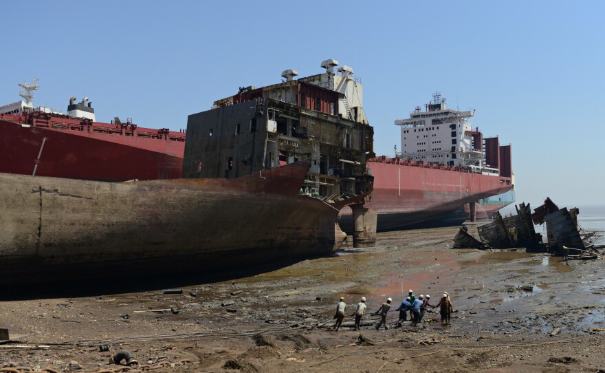 Indian shipbreakers work at the Sosiya-Alang Ship Recycling yard on March 4, 2013. Many ships are heading to scrap heaps, like this one, the world's largest, to help reduce the number competing for market share.