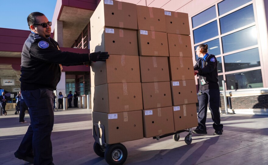 TSA staff members at Harry Reid International Airport in Las Vegas unload donated lunches from MGM Resorts on Wednesday as a partial government shutdown continues, and workers stopped receiving paychecks.