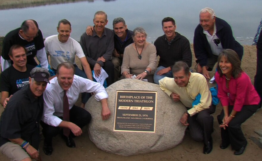 Mayor Kevin Faulconer, Councilmember Lorie Zapf, and the original triathletes gather around the plaque for a photo, February 20, 2015.