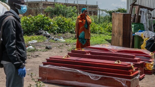 Family members of people who died of Ebola stand next to coffins at a health center in Rwampara, Congo, Wednesday, May 20, 2026.