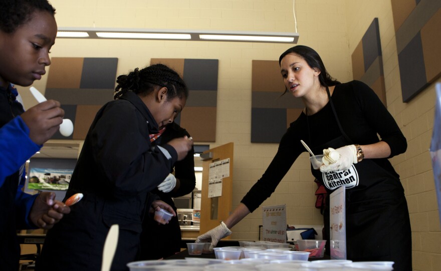 Katie Nash (Right) hands out the selection of carrots for the students at Walker-Jones to sample.