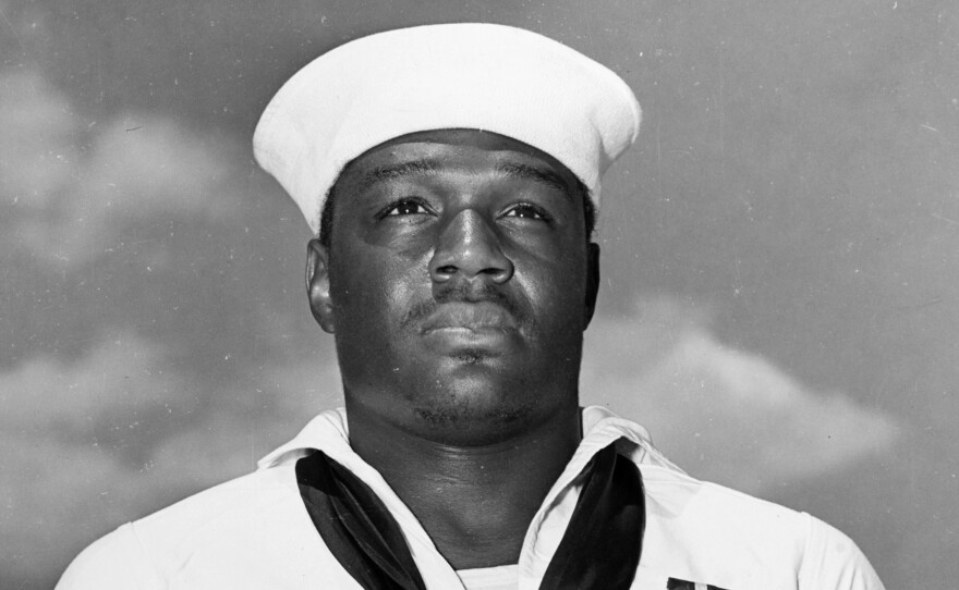 In this photo taken May 27, 1942, Mess Attendant 2nd Class Doris Miller stands at attention after being awarded the Navy Cross for for his actions aboard the USS West Virginia during the Japanese attack on Pearl Harbor on Dec. 7, 1941.