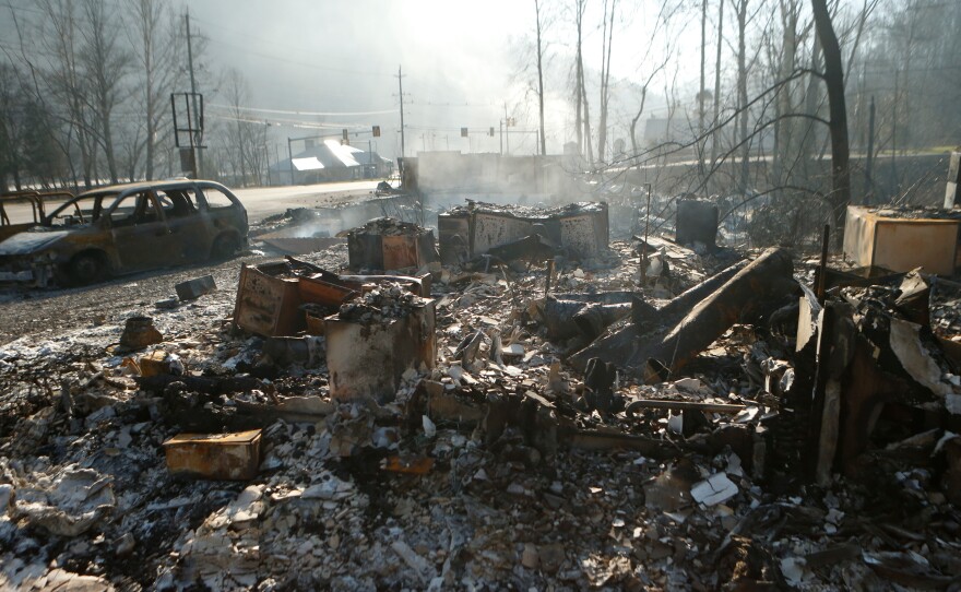 The remains of a business in Gatlinburg, Tenn., smolder on Nov. 29, after a devastating wildfire damaged or destroyed more than 2,000 buildings and killed at least 14 people.