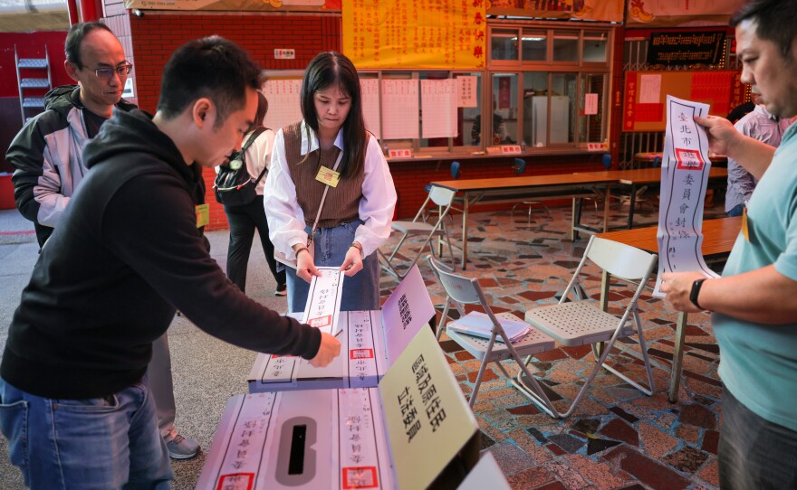 Election workers in Taipei, Taiwan, inspect boxes containing ballots as counting got underway on Jan. 13, 2024. China unsuccessfully sought to influence Taiwan's elections via social media, including TikTok.