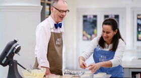 A behind-the-scenes photo of Host Christopher Kimball and Milk Street Cook Erika Bruce. 