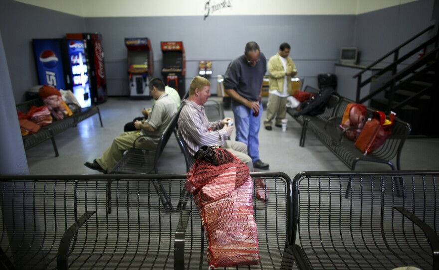 In the waiting room in the Huntsville Greyhound station, released inmates carry their belongings from prison in potato sacks, usually consisting of a Bible, some self-help books, and toiletries.