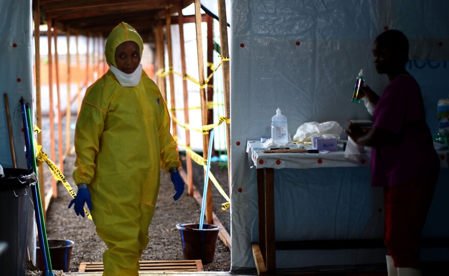 A nurse dons protective gear before entering the new Ebola treatment facility in Monrovia.