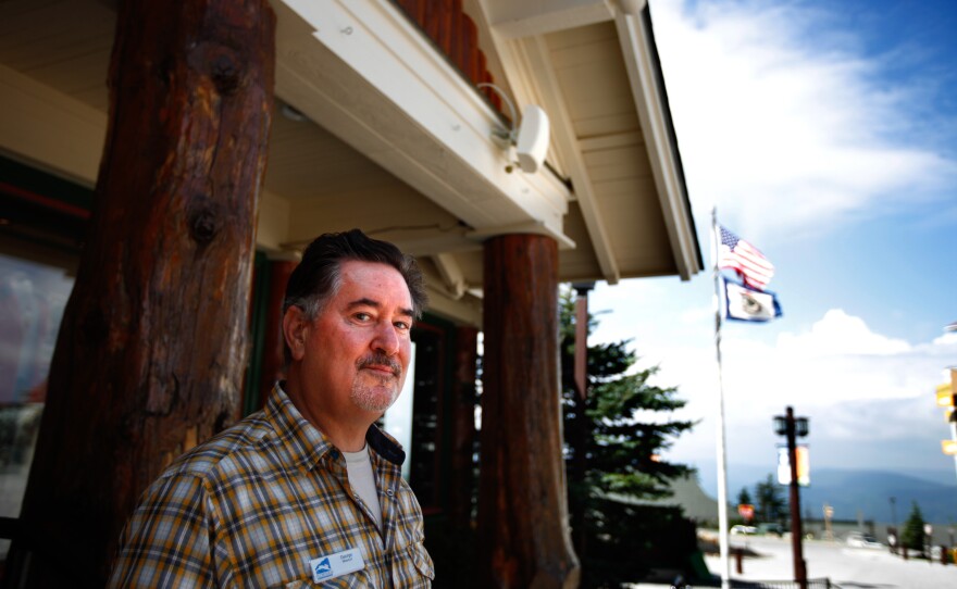 George Murphy is the IT director of Snowshoe Mountain Resort, which is within the 10-mile radio quiet boundary of the NRAO telescope. He's had to find inventive ways to bring connectivity to the resort, including installing short-range cell receivers like the one shown here, mounted on the building behind him.