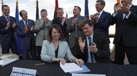 Interior Department official Tim Petty, front right, and Bureau of Reclamation chief Brenda Burman, front left, celebrate with representatives from seven states during a ceremony for a Colorado River drought contingency plan, Monday, May 20, 2019, in Boulder City, Nev.