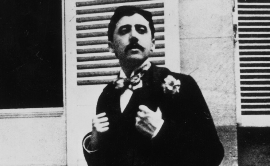 In this photograph, taken circa 1910, Marcel Proust poses outside a window. The image places Proust roughly a few years before the publication of the first volume of his masterpiece, In Search of Lost Time.