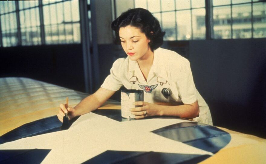 Woman painting an airplane, World War II