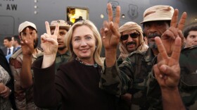 The U.S. is still trying to formulate new policies for the fast-changing politics of the Middle East. Here, Hillary Clinton stands with Libyan fighters who ousted Moammar Gadhafi during an Oct. 18 visit by the U.S. secretary of state to the capital Tripoli.