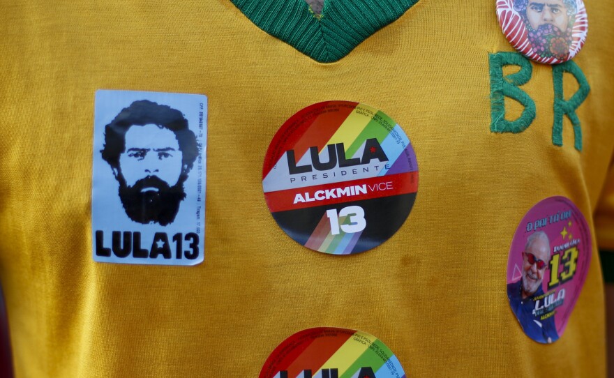 A supporter of Brazilian President-elect Luiz Inácio Lula da Silva wears a shirt with election campaign stickers during the runoff vote in Rio de Janeiro, Oct. 30.