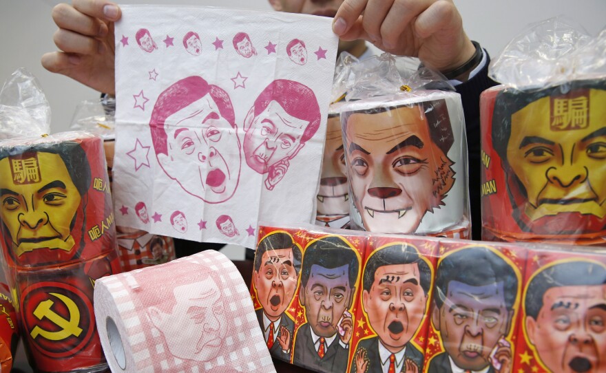 Rolls of toilet paper and packages of tissue paper printed with images of pro-Beijing Hong Kong Chief Executive Leung Chun-ying are shown Democratic Party Vice Chairman Lo Kin-hei in Hong Kong on Saturday.