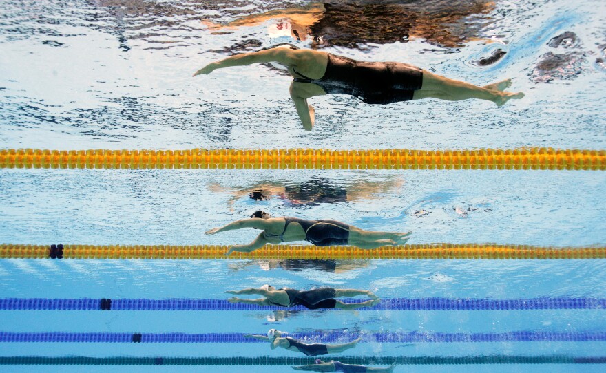 Fu Yuanhui of China is fourth from the front lane in a semifinal race for the women's 100m backstroke at the Rio Games.