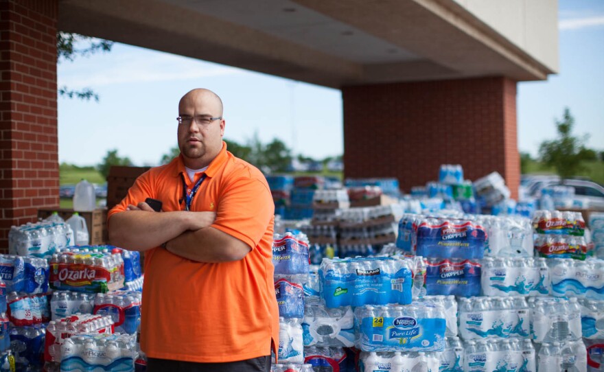 Kyle Duncan, the business administrator at the First Baptist Church, stands by the donation staging area where people have dropped off goods.